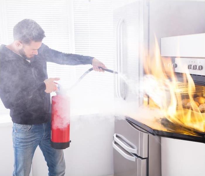 man extinguishing a fire in his home